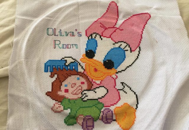Baby Daisy with doll cross stitch work photo Facebook Fan Joanne Powell